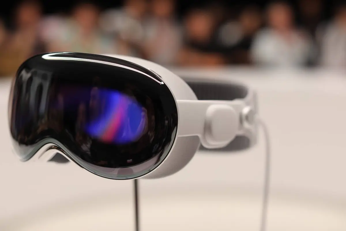 Close-up of sleek, modern VR headset with reflective black visor on a blurred background.
