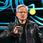 Person in black jacket holding a chip, with abstract blue and orange background lines.