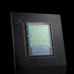 Close-up of a computer chip with intricate circuitry on a black background.