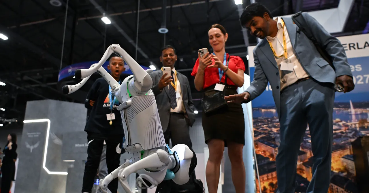 A robot interacts with a group of people taking photos at an indoor tech event, with banners and displays in the background.