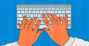 Hands typing on a keyboard against a blue background, viewed from above.