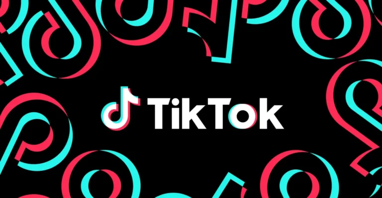 TikTok logo centered on a black background with red and blue abstract shapes surrounding it.