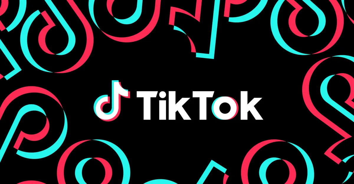 TikTok logo centered on a black background with red and blue abstract shapes surrounding it.