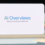 Person standing on stage beside a large screen displaying "AI Overviews, rolling out in US and more countries soon.