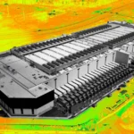 Aerial view of a large data center with a vivid, digitally altered background in yellow and green tones.