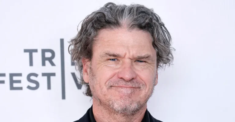 Man with gray hair and a slight smile against a backdrop with partial text "TR FEST".