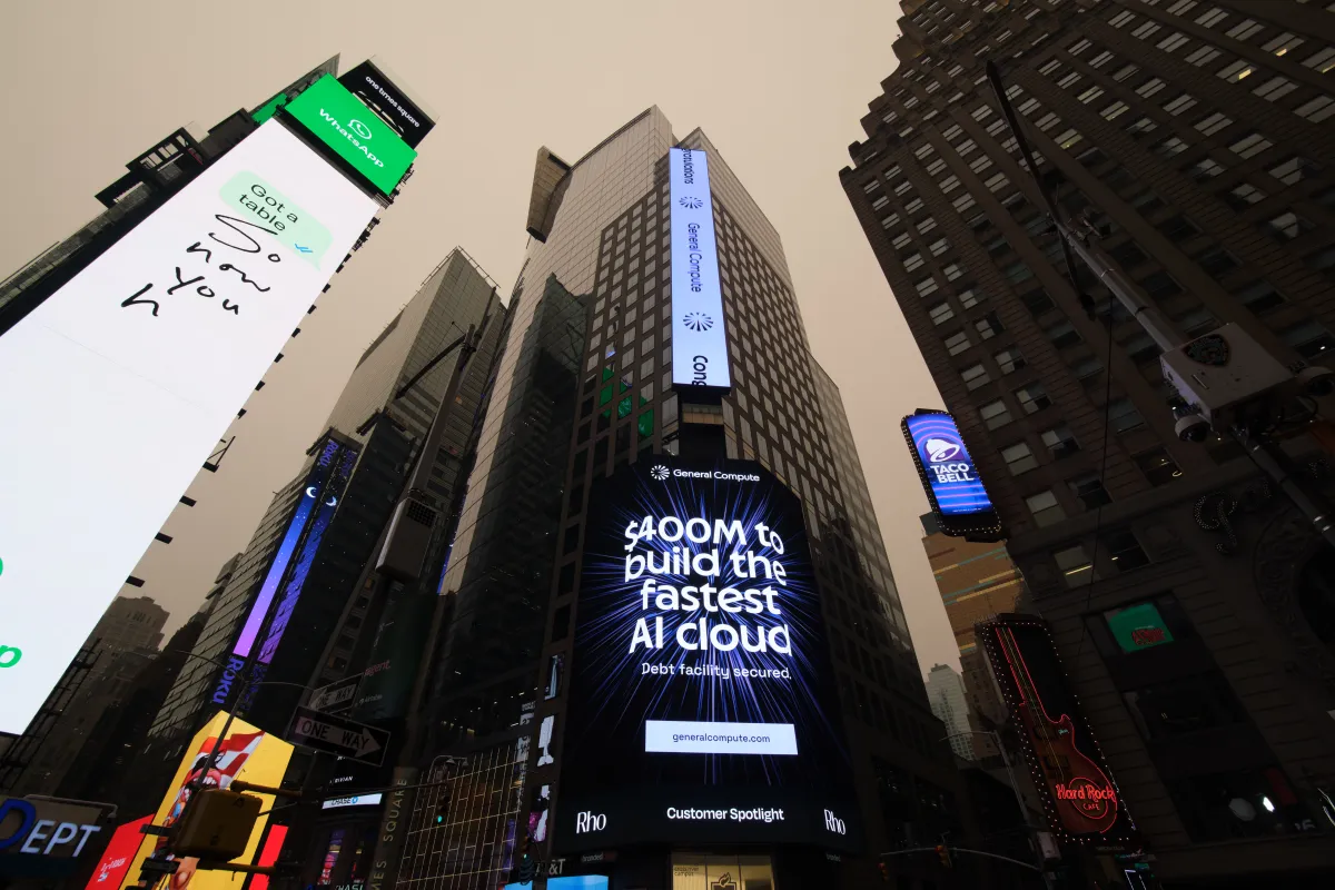 Skyscraper billboards display ads, including "$400M to build the fastest AI cloud" by General Compute, in a cityscape.