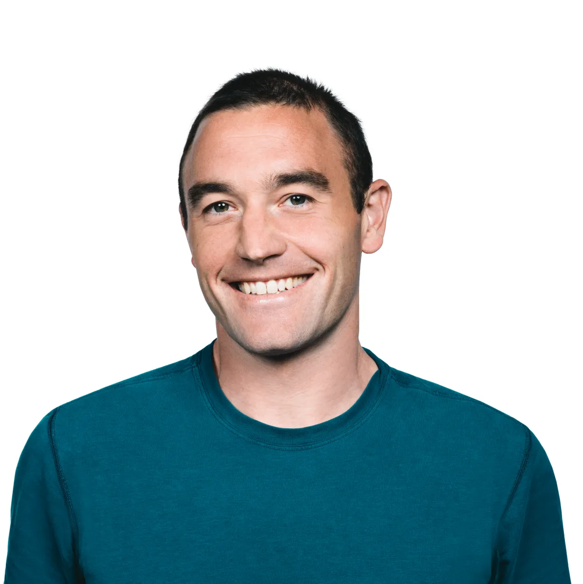 Smiling person in a teal shirt against a plain white background.