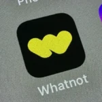 Whatnot app icon with a yellow logo on a black background, displayed on a smartphone screen alongside other app icons.