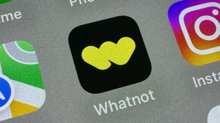 Whatnot app icon with a yellow logo on a black background, displayed on a smartphone screen alongside other app icons.