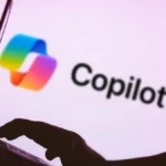 Silhouette of a person typing on a laptop with the Copilot logo and text on a pink background.