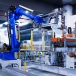 physical AI robot training in a San Leandro warehouse with sensor headset and robotic arm