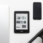 Reading apps setup with e-reader tablet and note-taking devices on a desk