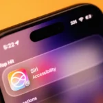 Close-up of an iPhone screen displaying Siri accessibility settings with a colorful icon, time, and signal indicators.