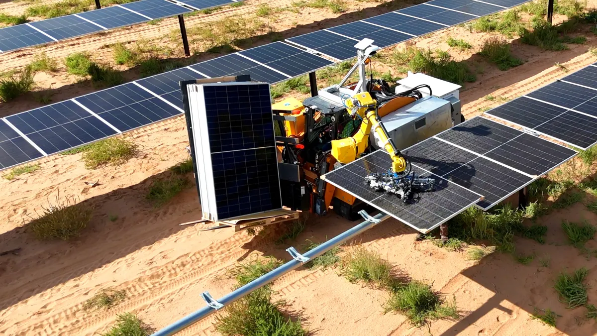 Robot arm installing solar panels on a construction site in a desert landscape, surrounded by rows of existing panels.
