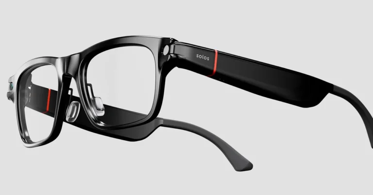 Black smart glasses with clear lenses, camera on left side, and "solos" text on the temple, set against a gray background.