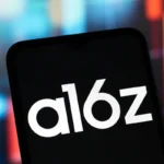 Smartphone screen displaying "a16z" logo, blurred colorful background.