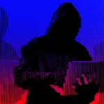 Silhouetted figure in a hoodie using a laptop against a striped blue and red background.