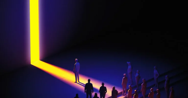 Silhouetted figures stand in a dark space facing a bright, vertical light beam.