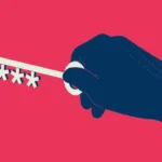 Dark blue hand holding a key with asterisks facing a keyhole, on a red background.