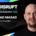 Man with a goatee on a black dotted background, text reads: "TechCrunch Disrupt, Oct 13-15, San Francisco, Amjad Masad, CE...