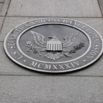 U.S. Securities and Exchange Commission seal on a stone wall, featuring an eagle with shield and inscriptions.
