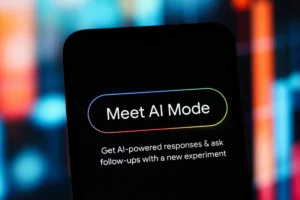 Smartphone screen displaying "Meet AI Mode" with a prompt about AI-powered responses, set against a blurred colorful backg...