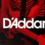 Person in a striped shirt playing guitar, D'Addario logo prominently displayed over the image.