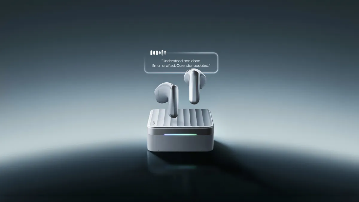 Two earbuds hover above a charging case with text bubble: "Understood and done. Email drafted. Calendar updated.