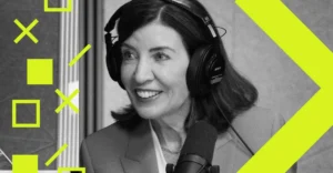 Woman in headphones speaking into a microphone, geometric yellow shapes overlayed, grayscale image.