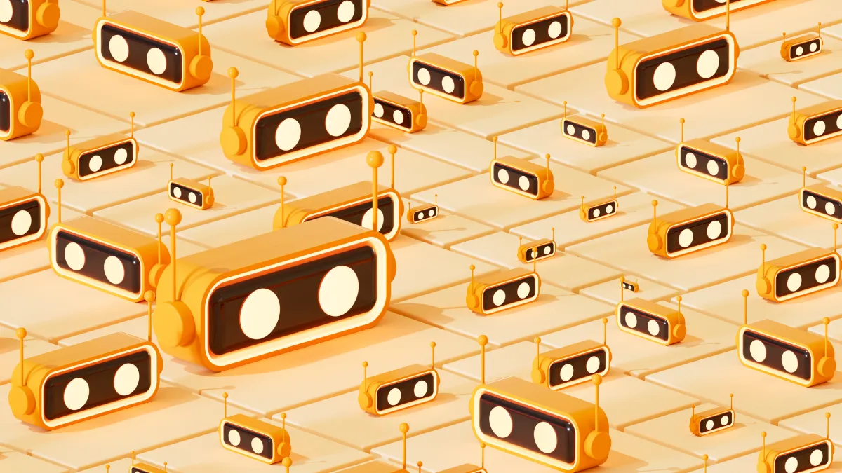 Numerous orange robot faces with antennas arranged in a pattern on a tiled surface.