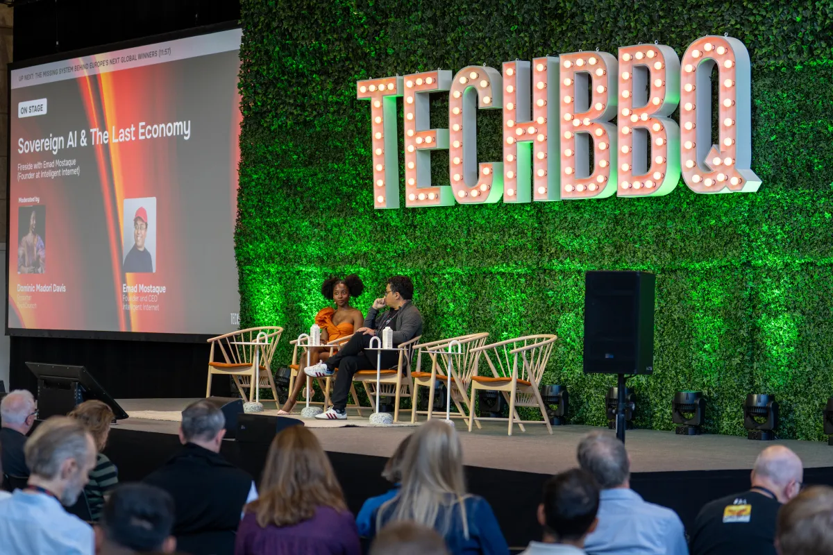 Speakers seated on stage at TechBBQ event, discussing "Sovereign AI & The Last Economy" with audience in foreground.
