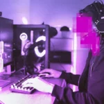 Person wearing headphones and cap using a computer with pink pixelated face, gaming setup illuminated by purple light.