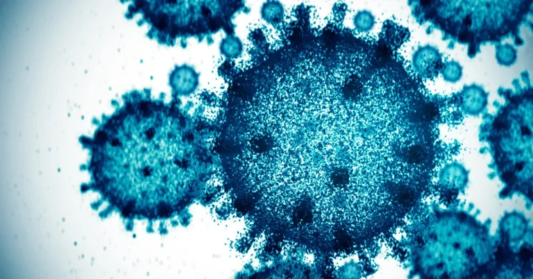 Close-up view of blue microscopic structures resembling viruses or cells on a white background.
