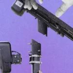 Hands assembling a camera and mounting pole against a purple background.