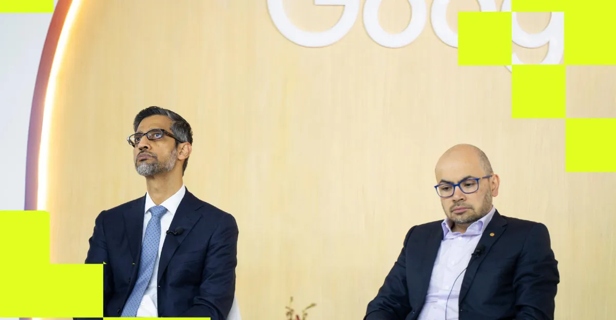 Two men in suits sit in front of a wooden wall with partial Google logo, yellow geometric overlay elements.
