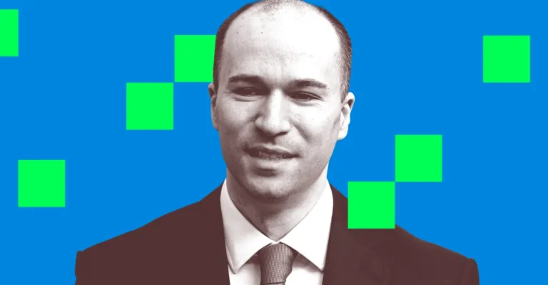 Man in a suit with a neutral expression, blue background with green squares.