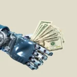 Robotic hand holding a fan of US dollar bills against a plain background.