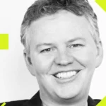 Smiling man with short hair, geometric shapes and lines in neon yellow on black background.