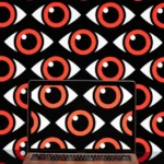 Laptop displaying red and white eye pattern, matching the background, symbolizing surveillance or scrutiny.