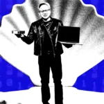 Man in leather jacket holding a laptop and a device stands against a large shell backdrop, binary code background.