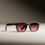Smart glasses with black frames and tinted lenses on a neutral background.