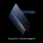 Sleek laptop with a rainbow sheen, text bubble "Let Gemini help with that," and caption "Designed for Gemini Intelligence.