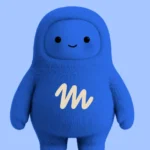 Blue, furry humanoid character with a smiling face and "m" logo on chest, set against a light blue background