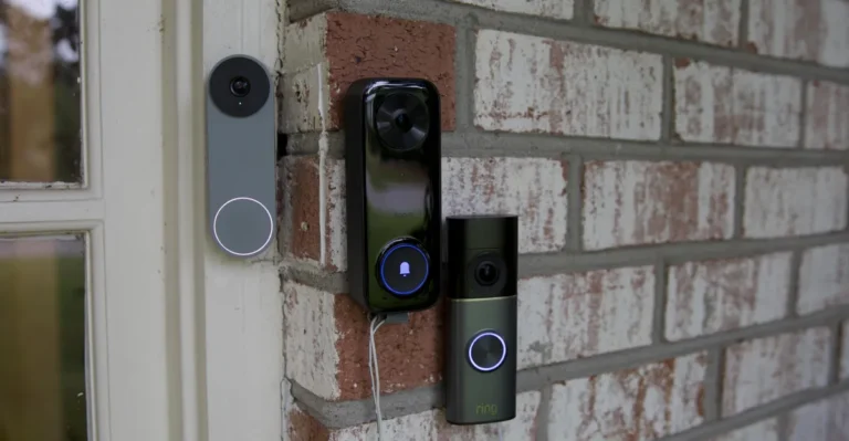 Three smart doorbell cameras mounted on a brick wall, each with illuminated rings and cameras facing outward.