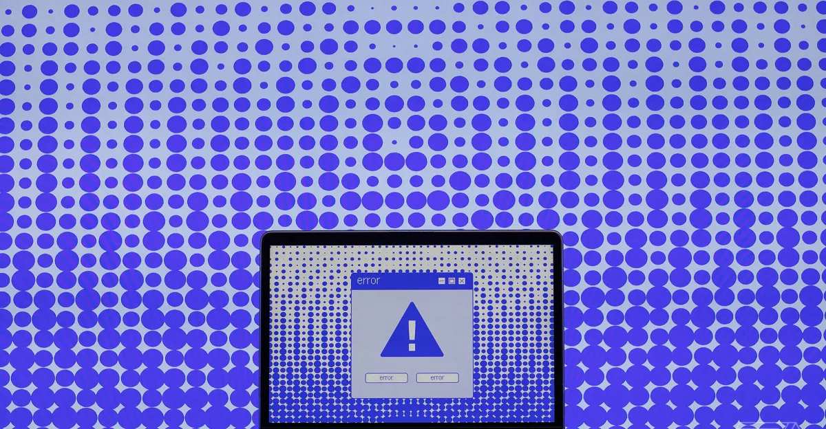 Laptop screen displaying error message with exclamation mark, set against a blue polka dot pattern background