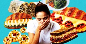 Woman covering mouth surrounded by surreal, textured food items including sandwiches, pastries, and a salad on a blue back...