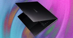 Lenovo Yoga laptop partially open, displaying keyboard on a vibrant, colorful background.