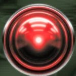 Red glowing lens resembling a camera or eye on a dark, blurred background.