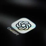 ChatGPT app icon on a dark screen, featuring the OpenAI logo and text "ChatGPT" beneath.